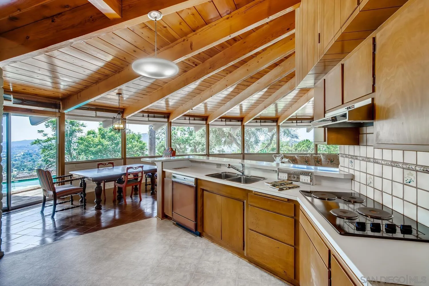 14565 High Valley Road Poway, CA 92064 - Photo 10 of 28 a kitchen that has a sink a stove and a table
