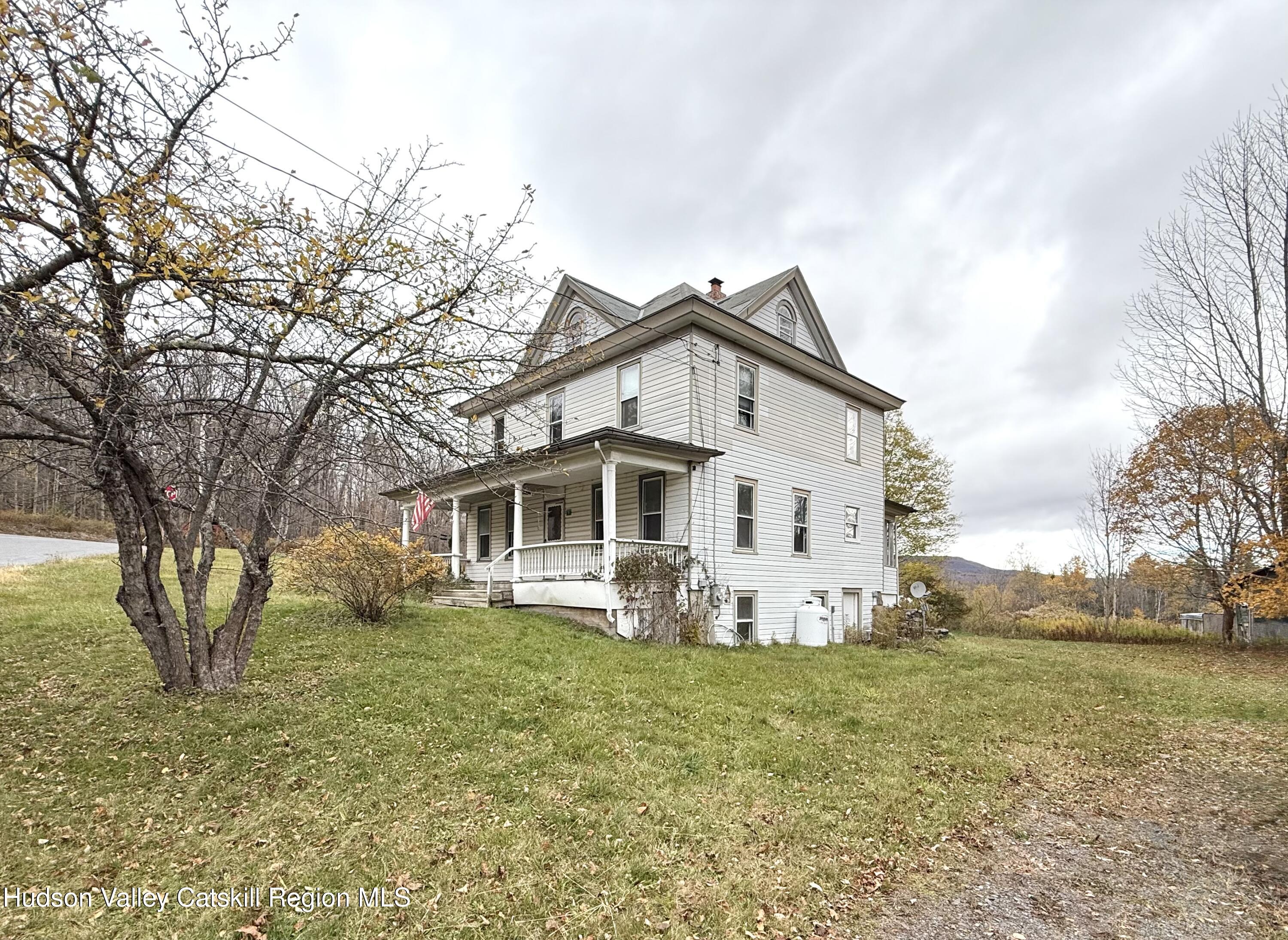 5 Clum Hill Road Haines Falls, NY 12436 - Photo 2 of 14 a white house with a big yard and large trees