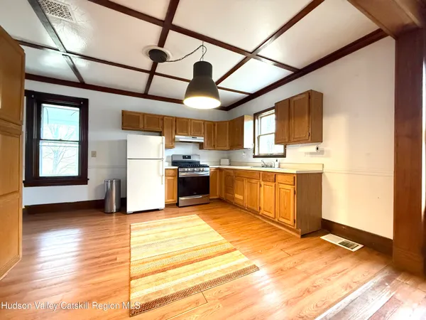 a kitchen with stainless steel appliances granite countertop a sink window and cabinets