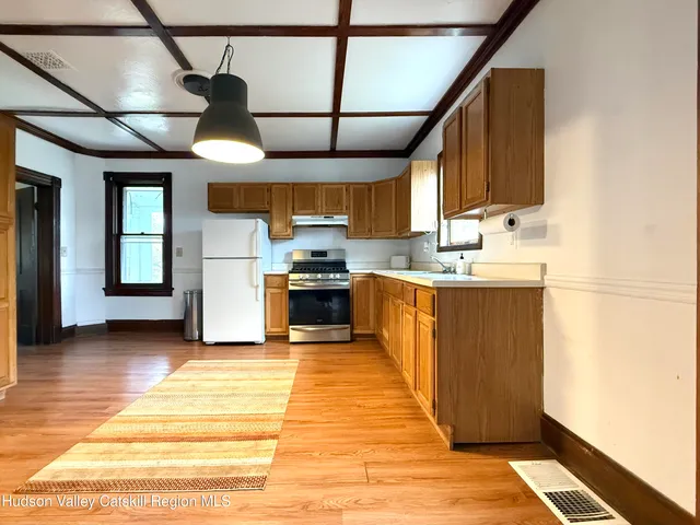 a kitchen with stainless steel appliances kitchen island granite countertop a sink and cabinets