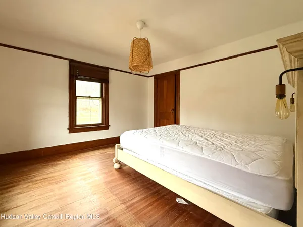 a bed sitting in a bedroom next to a window