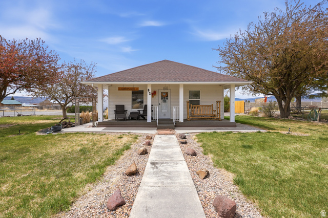 82 South 100 West Lyman, UT 84749 - Photo 11 of 27 View of front of home featuring a porch and roof with shingles