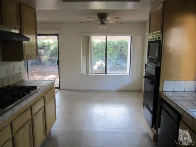 237 Village Road Port Hueneme, CA 93041 - Photo 7 of 30 a kitchen that has a stove and a wooden floor