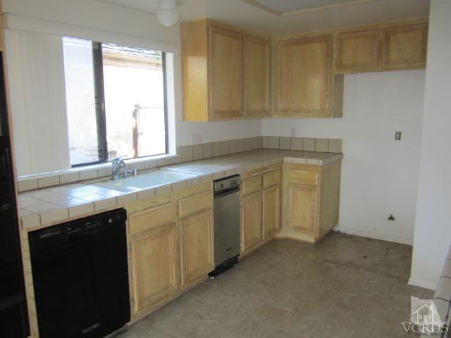237 Village Road Port Hueneme, CA 93041 - Photo 8 of 30 a kitchen with white cabinets and a sink