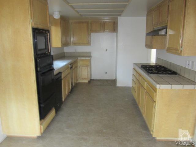 237 Village Road Port Hueneme, CA 93041 - Photo 9 of 30 a kitchen with a stove and a refrigerator