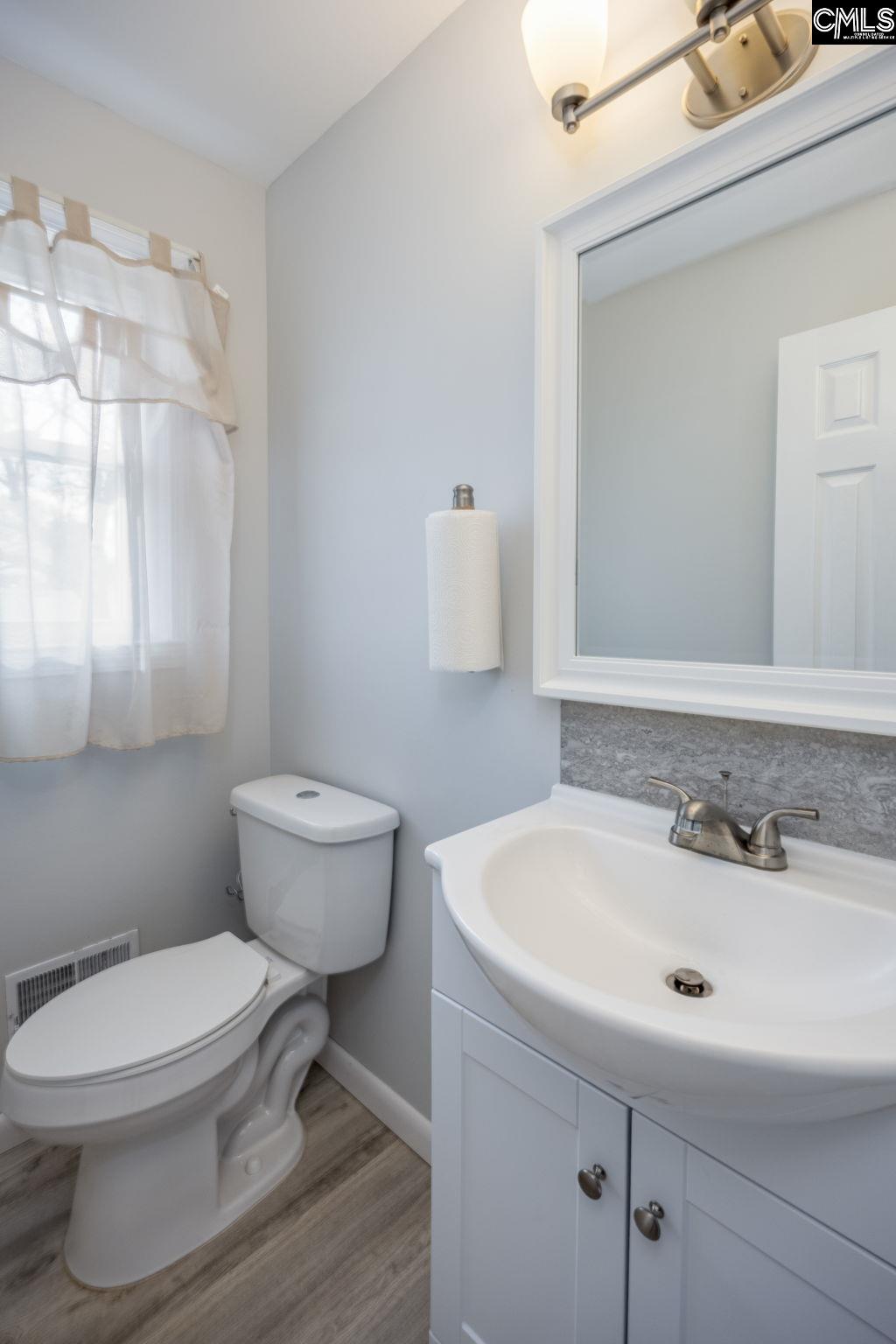 560 Edisto Street Batesburg, SC 29006 - Photo 22 of 49 a bathroom with a sink a toilet and a mirror
