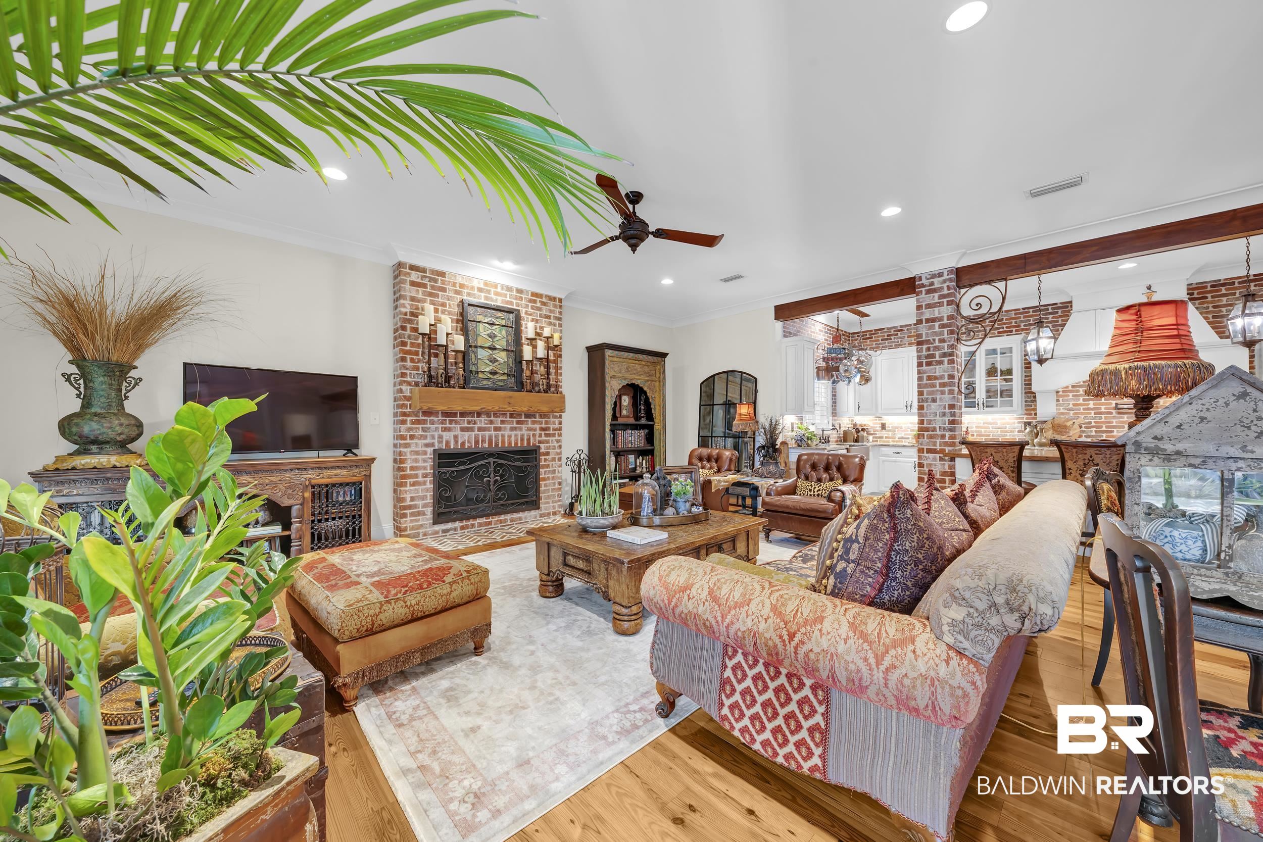12161 Jessamine Street Magnolia Springs, AL 36555 - Photo 11 of 70 Living area featuring a brick fireplace, wood-type flooring, ceiling fan, brick wall, and recessed lighting