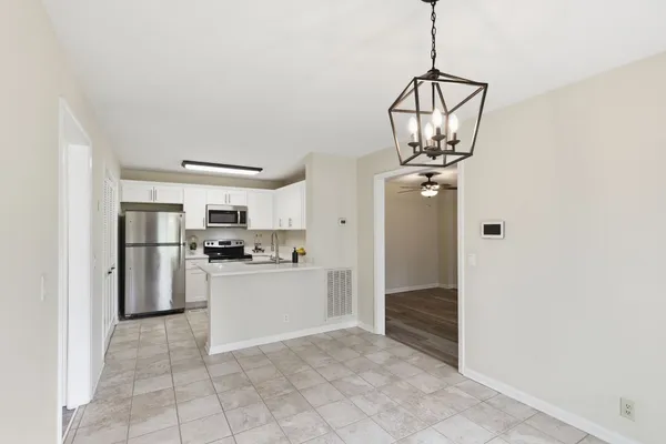 a kitchen with stainless steel appliances granite countertop a refrigerator and a stove top oven
