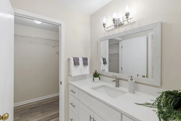a bathroom with a double vanity sink and a mirror