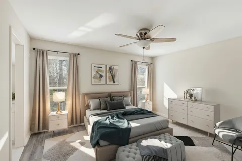 a bedroom with furniture and a window