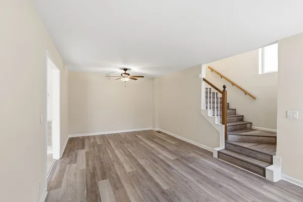 a view of room with stairs and wooden floor