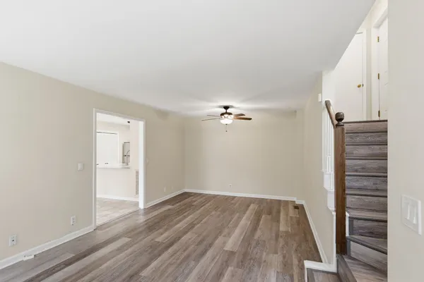 a view of empty room with wooden floor