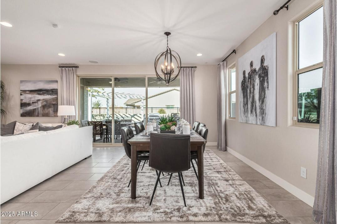 17386 West Bloomfield Road Surprise, AZ 85388 - Photo 11 of 31 a view of a dining room with furniture wooden floor and a chandelier