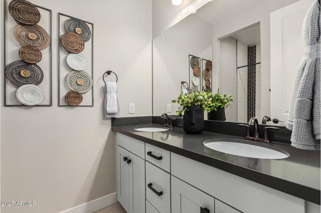 17386 West Bloomfield Road Surprise, AZ 85388 - Photo 25 of 31 a bathroom with a granite countertop sink and a mirror