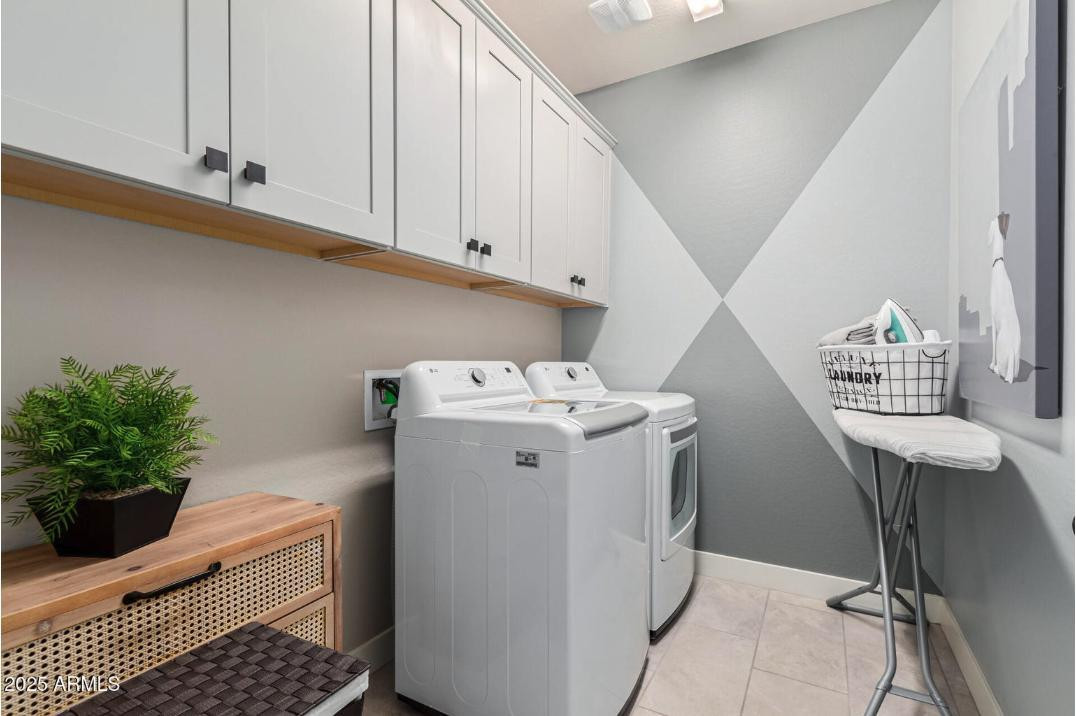17386 West Bloomfield Road Surprise, AZ 85388 - Photo 27 of 31 a utility room with cabinets washer and dryer