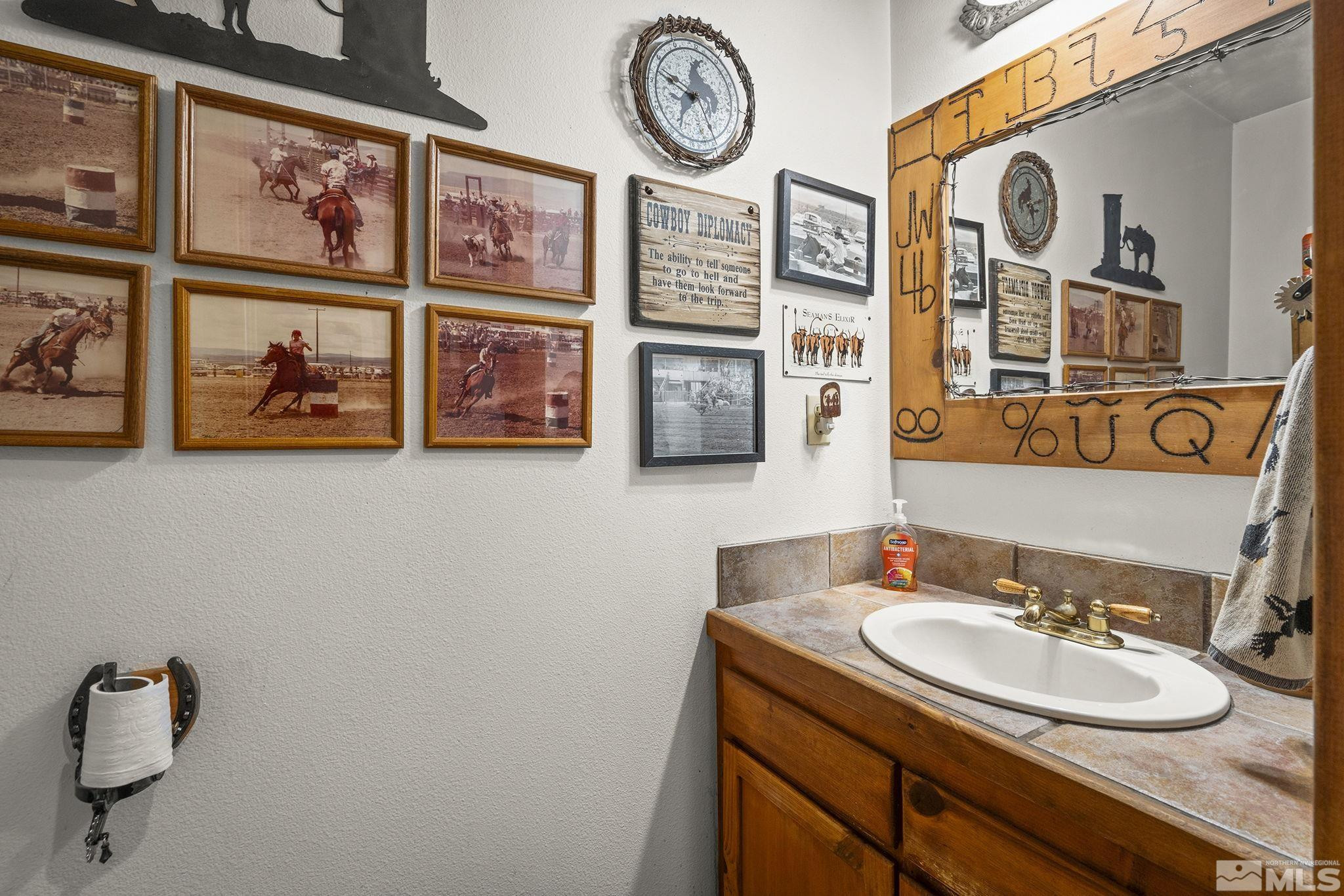6811 Reno Highway Fallon, NV 89406 - Photo 18 of 33 a bathroom with a granite countertop sink and a mirror