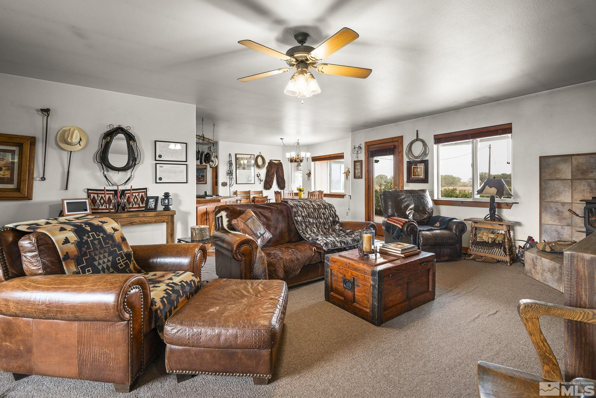 6811 Reno Highway Fallon, NV 89406 - Photo 5 of 33 a living room with furniture a large window and a chandelier