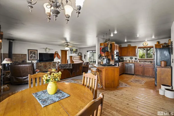 a living room with lots of furniture and kitchen view