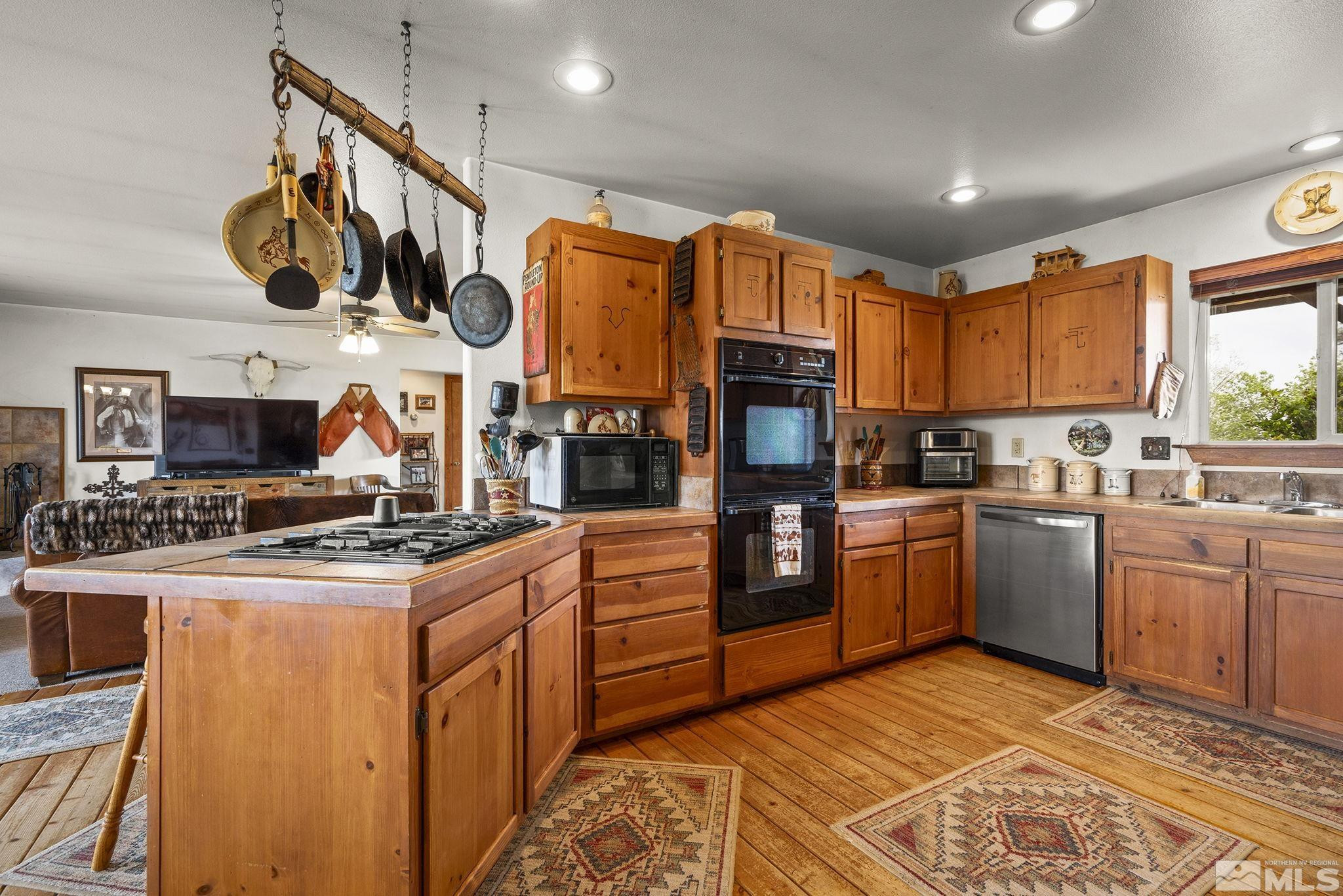 6811 Reno Highway Fallon, NV 89406 - Photo 9 of 33 a kitchen with stainless steel appliances granite countertop a stove a sink and a refrigerator