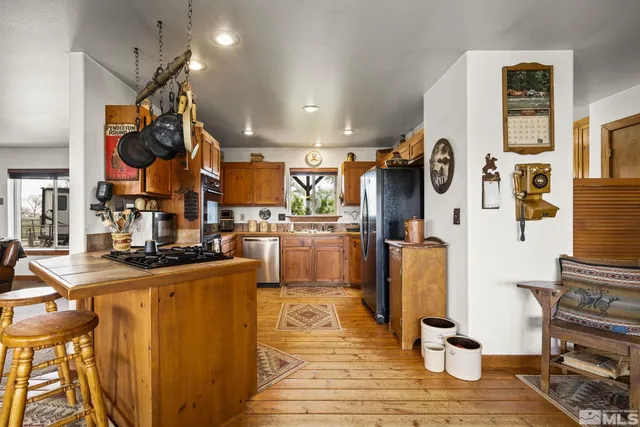 a view of a kitchen with furniture and wooden floor