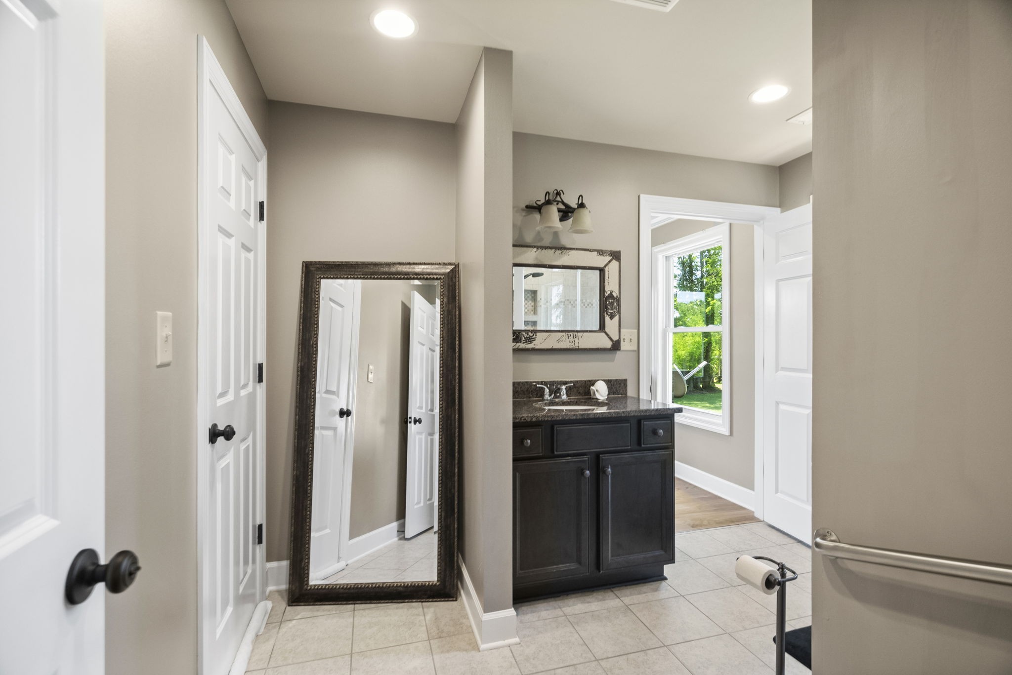 4266 Dot Road Springfield, TN 37172 - Photo 54 of 70 a bathroom with a granite countertop sink a mirror and a bathtub