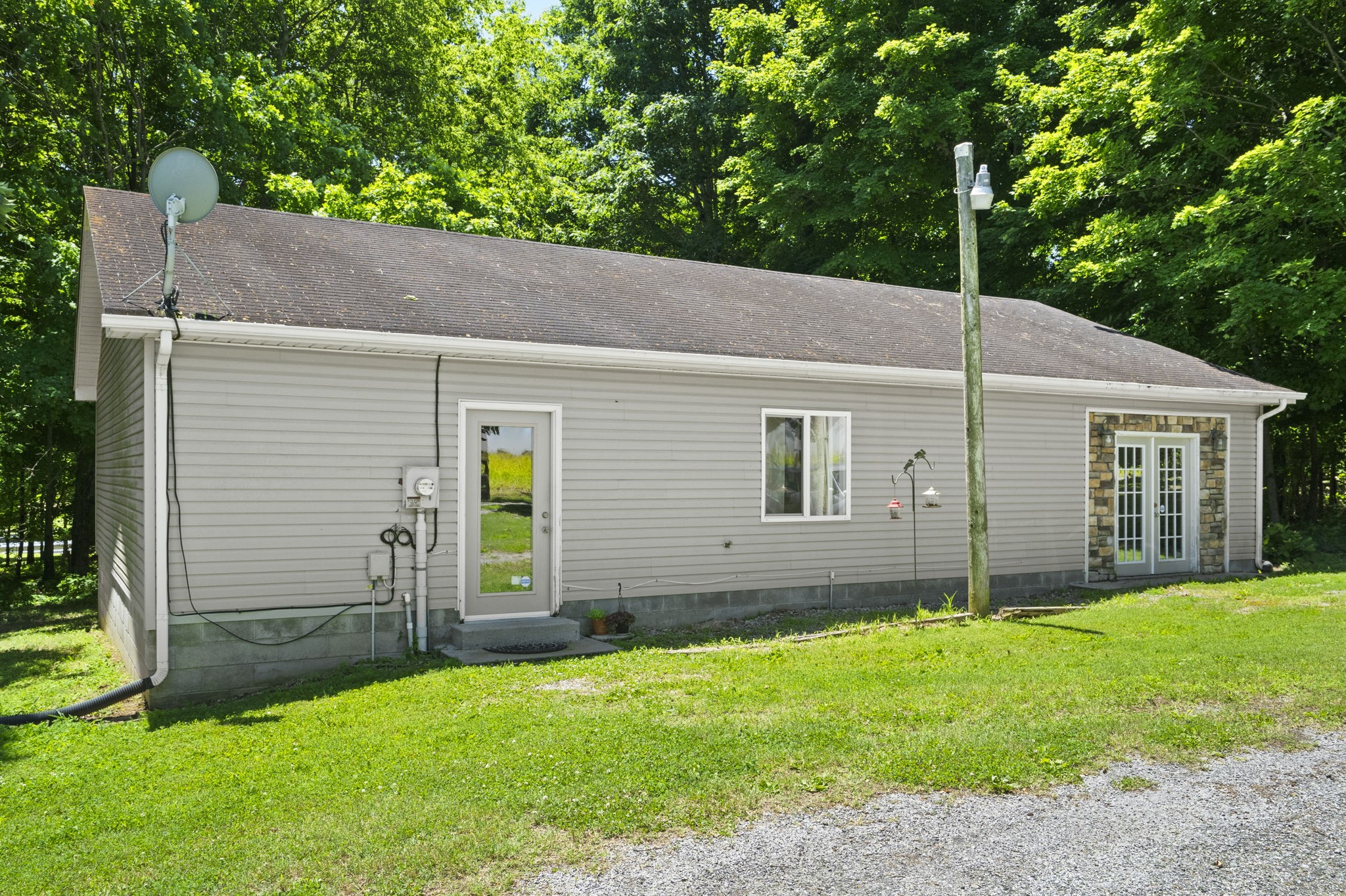 4266 Dot Road Springfield, TN 37172 - Photo 9 of 70 a backyard of a house with lawn chairs and a large tree