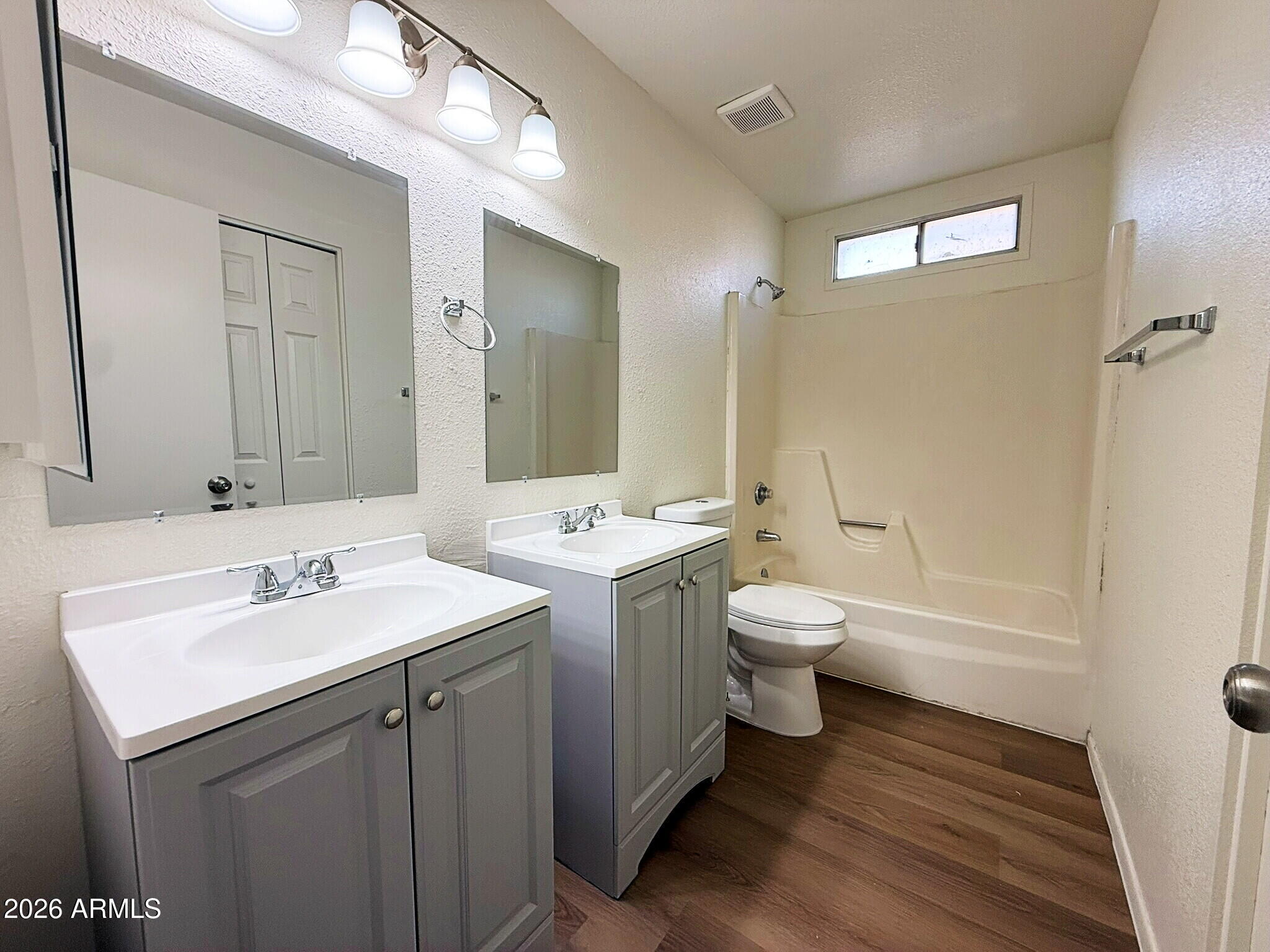 5208 West Calavar Road Glendale, AZ 85306 - Photo 35 of 39 a bathroom with a toilet sink and mirror