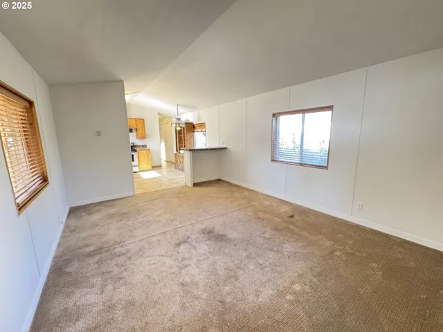 a view of house with backyard and seating area