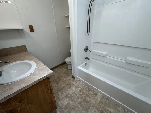 a bathroom with a tub sink and toilet