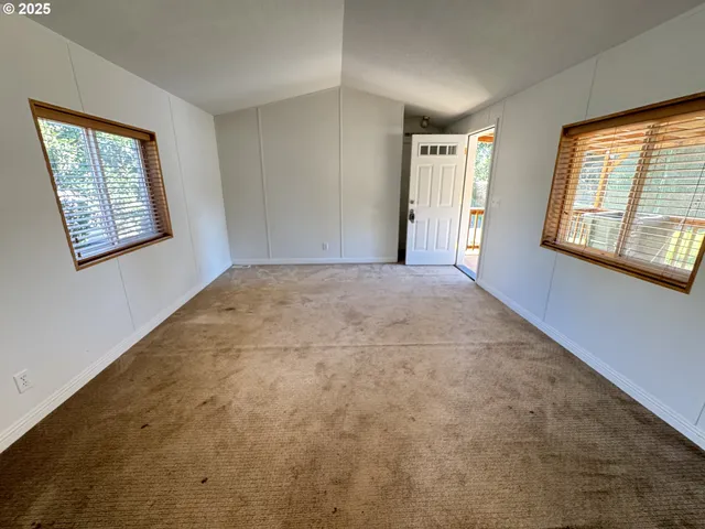 a kitchen with granite countertop a refrigerator a sink a stove a washer dryer and a refrigerator