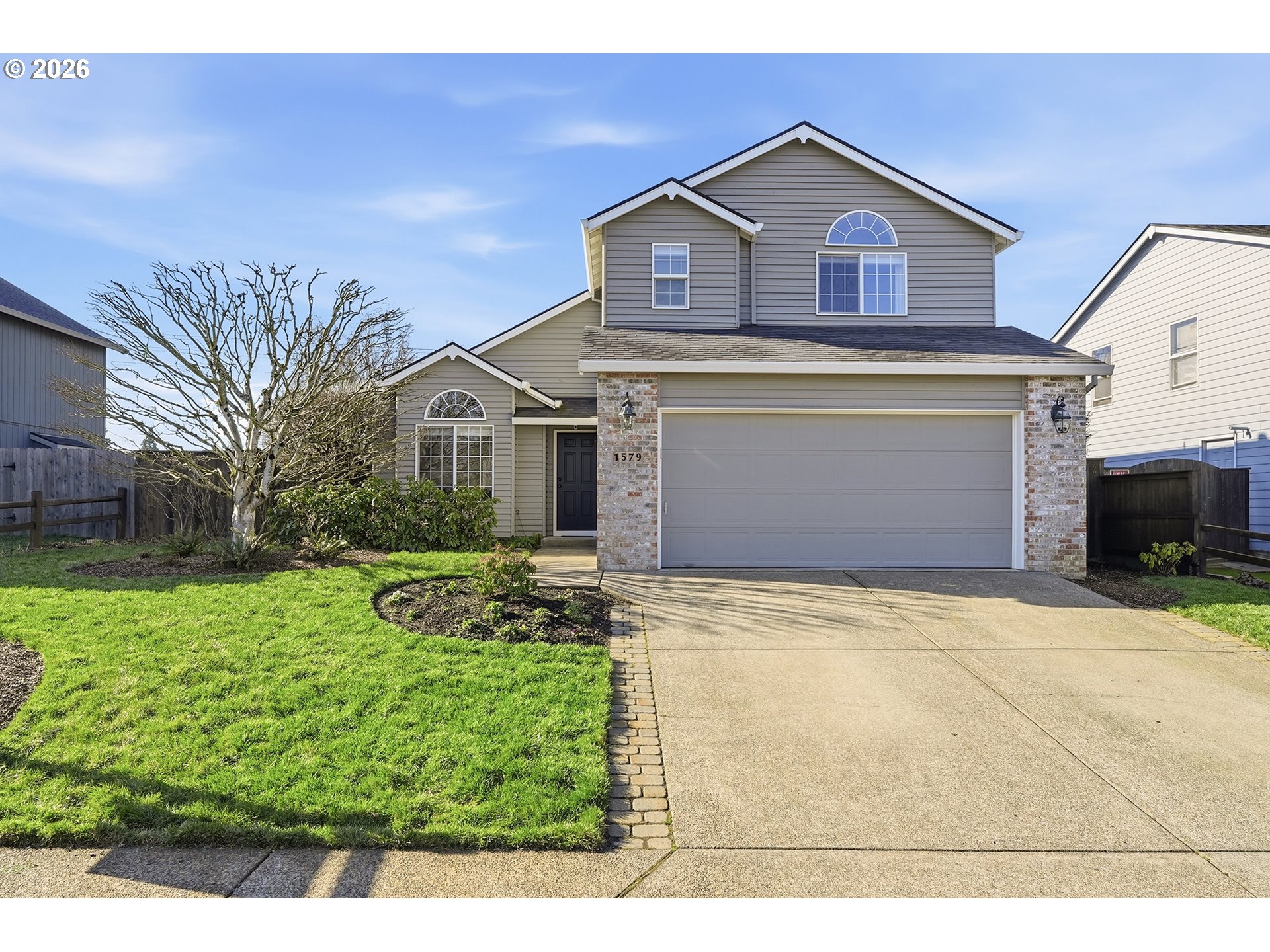 a front view of a house with a yard and garage