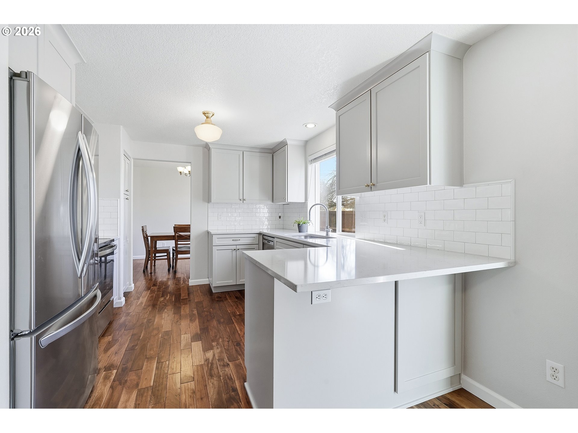 1579 Southwest 213th Avenue Beaverton, OR 97003 - Photo 15 of 48 a kitchen with kitchen island a sink stove and refrigerator