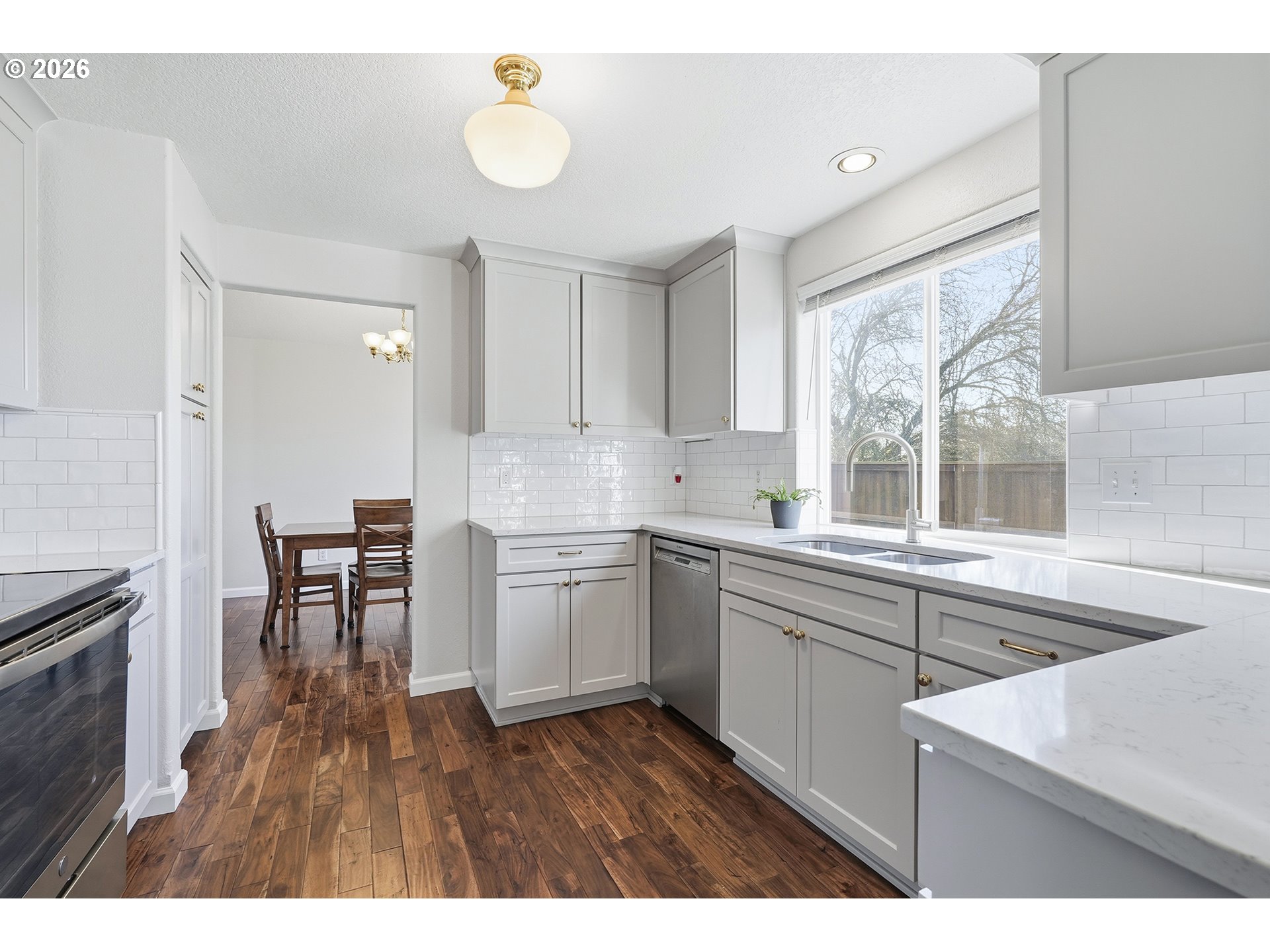 1579 Southwest 213th Avenue Beaverton, OR 97003 - Photo 16 of 48 a kitchen with a sink cabinets and wooden floor