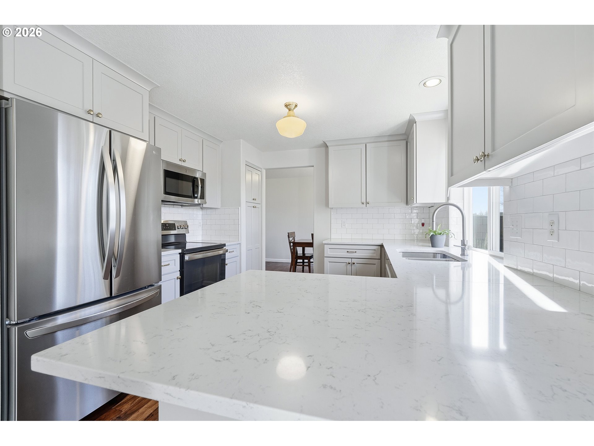 1579 Southwest 213th Avenue Beaverton, OR 97003 - Photo 17 of 48 a kitchen with stainless steel appliances kitchen island a refrigerator sink and cabinets