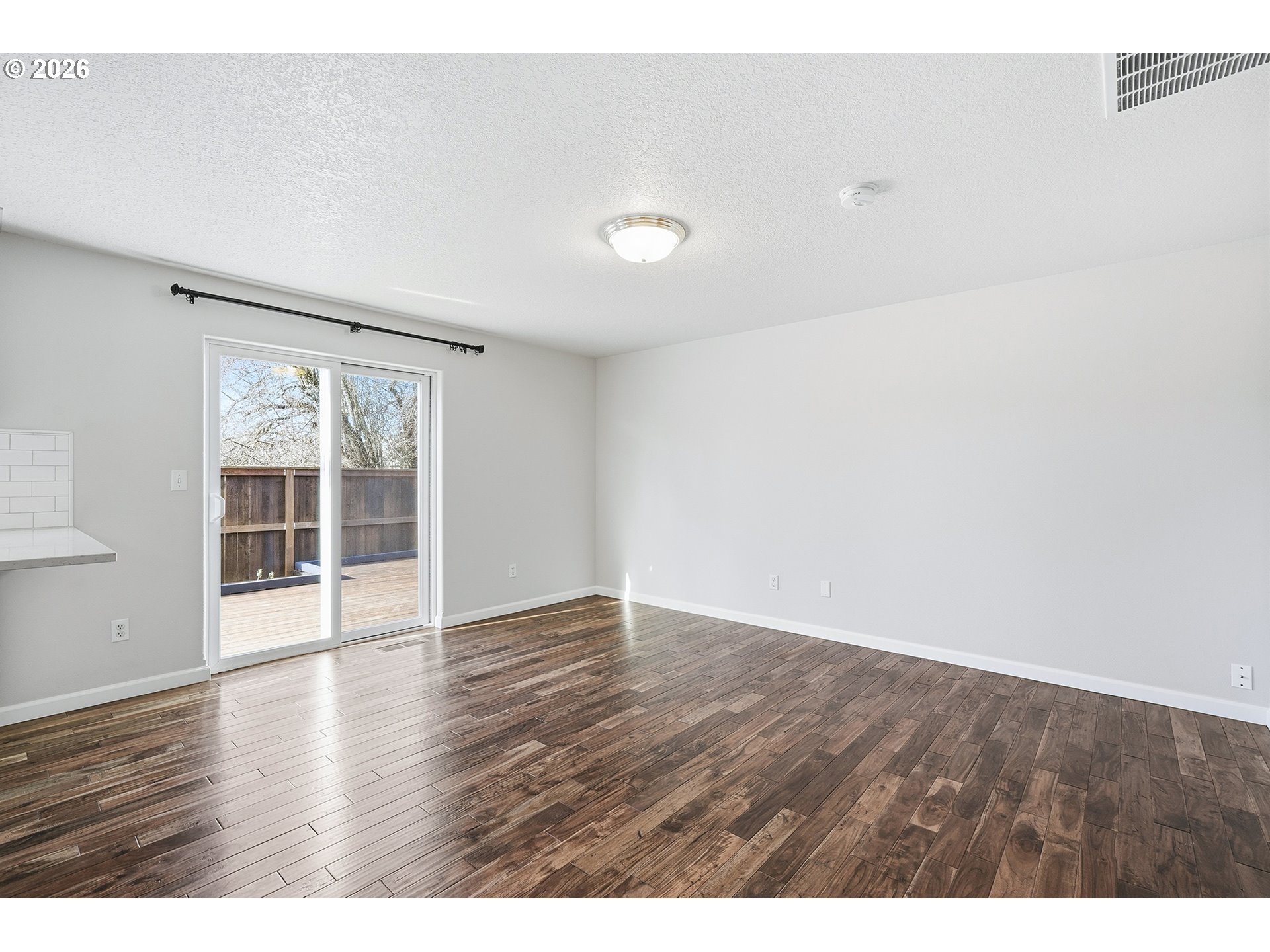 1579 Southwest 213th Avenue Beaverton, OR 97003 - Photo 20 of 48 a view of an empty room with wooden floor and a window