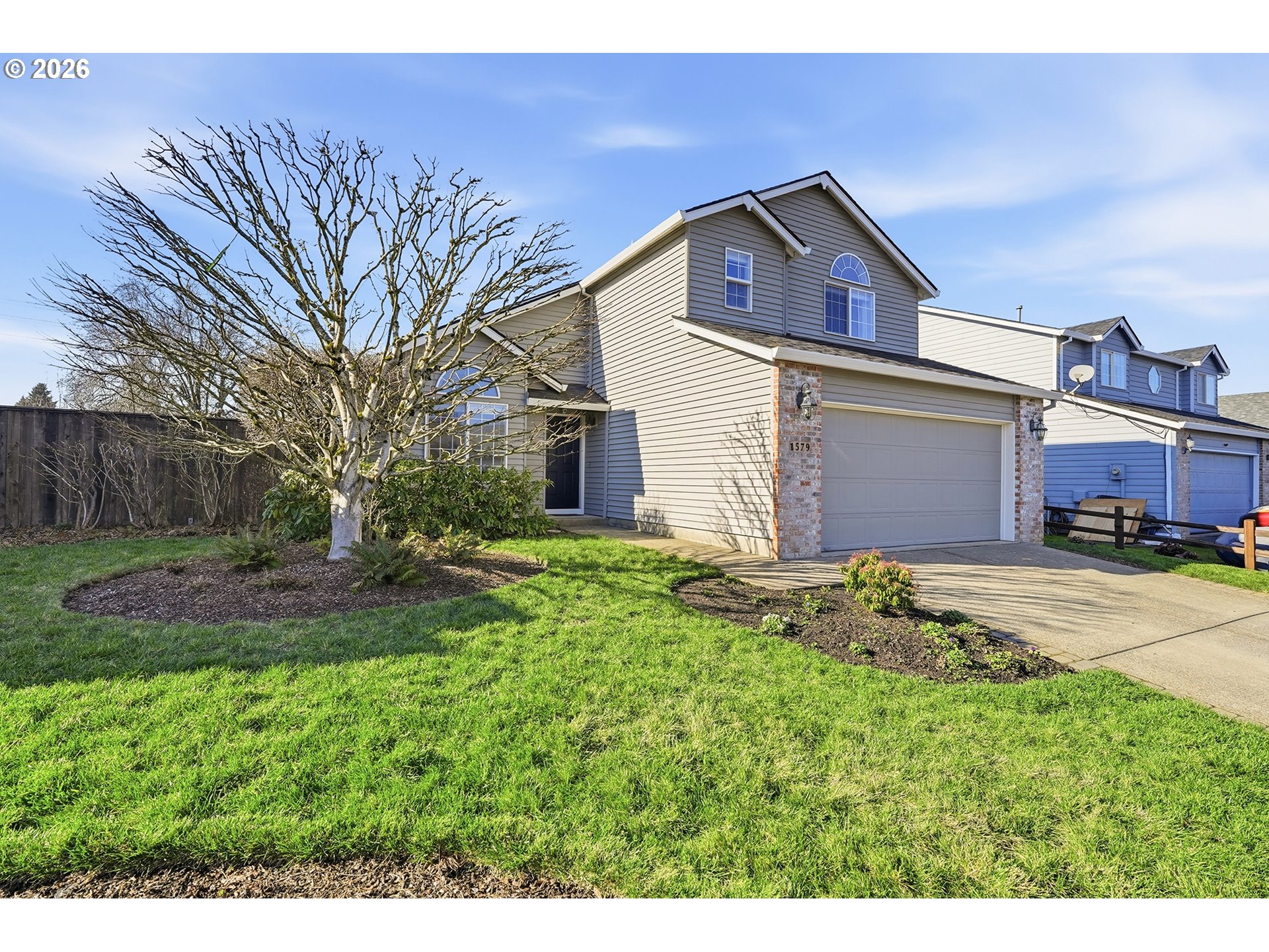 1579 Southwest 213th Avenue Beaverton, OR 97003 - Photo 2 of 48 a front view of a house with a garden and yard
