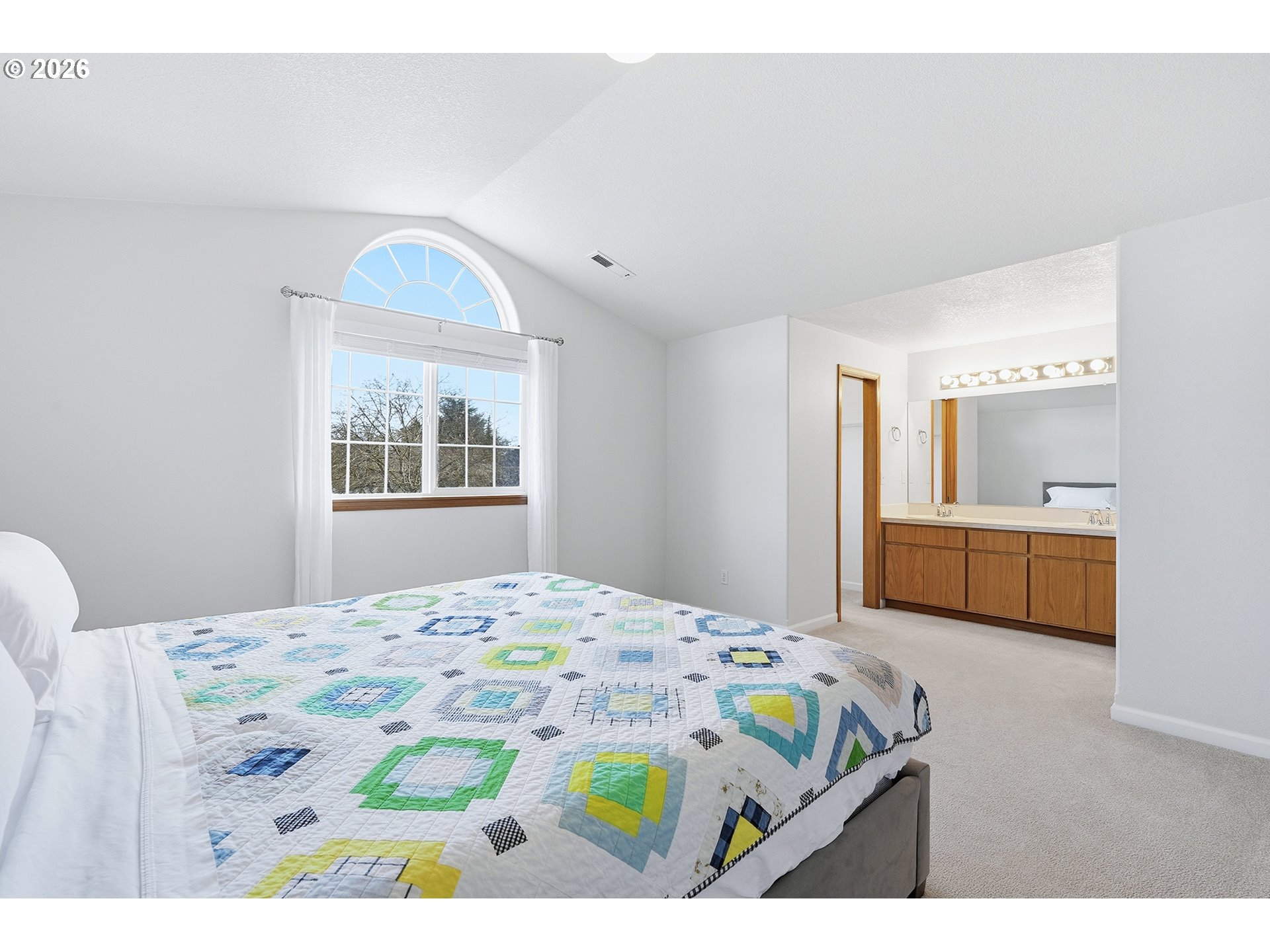 1579 Southwest 213th Avenue Beaverton, OR 97003 - Photo 31 of 48 a bedroom with a bed a mirror and a flat screen tv