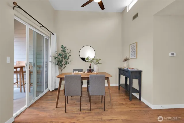 a view of a dining room with furniture and wooden floor
