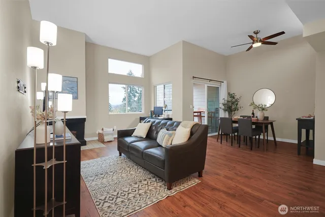 a living room with furniture and wooden floor