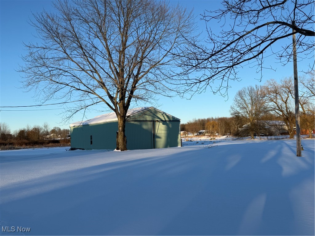 6747 Giddings Road Rootstown, OH 44272 - Photo 2 of 39 Yard covered in snow featuring a pole barn