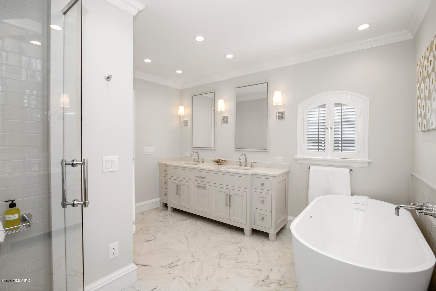 22 Normandy Lane Riverside, CT 06878 - Photo 21 of 34 a bathroom with a double vanity sink a mirror and a bathtub