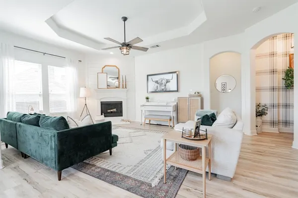a living room with furniture a fireplace and a large window
