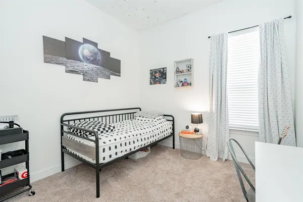 a bedroom with a bed and window