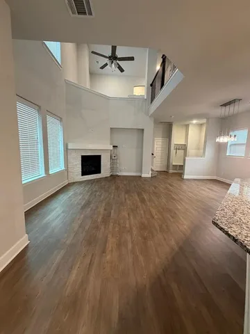a view of a livingroom with a fireplace and window