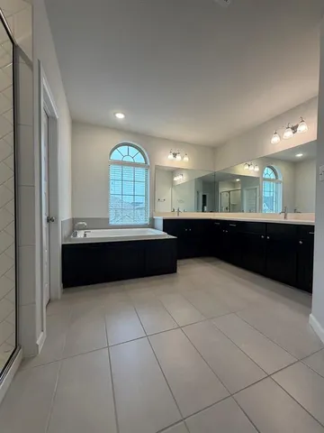 a large bathroom with a large tub and sink