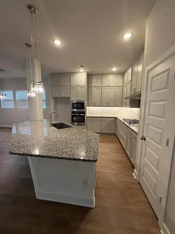 a large kitchen with kitchen island granite countertop a large counter top