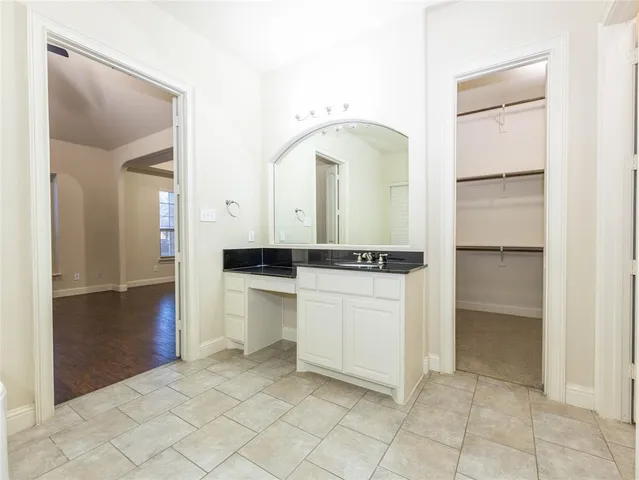 a room with a walk in closet and mirror