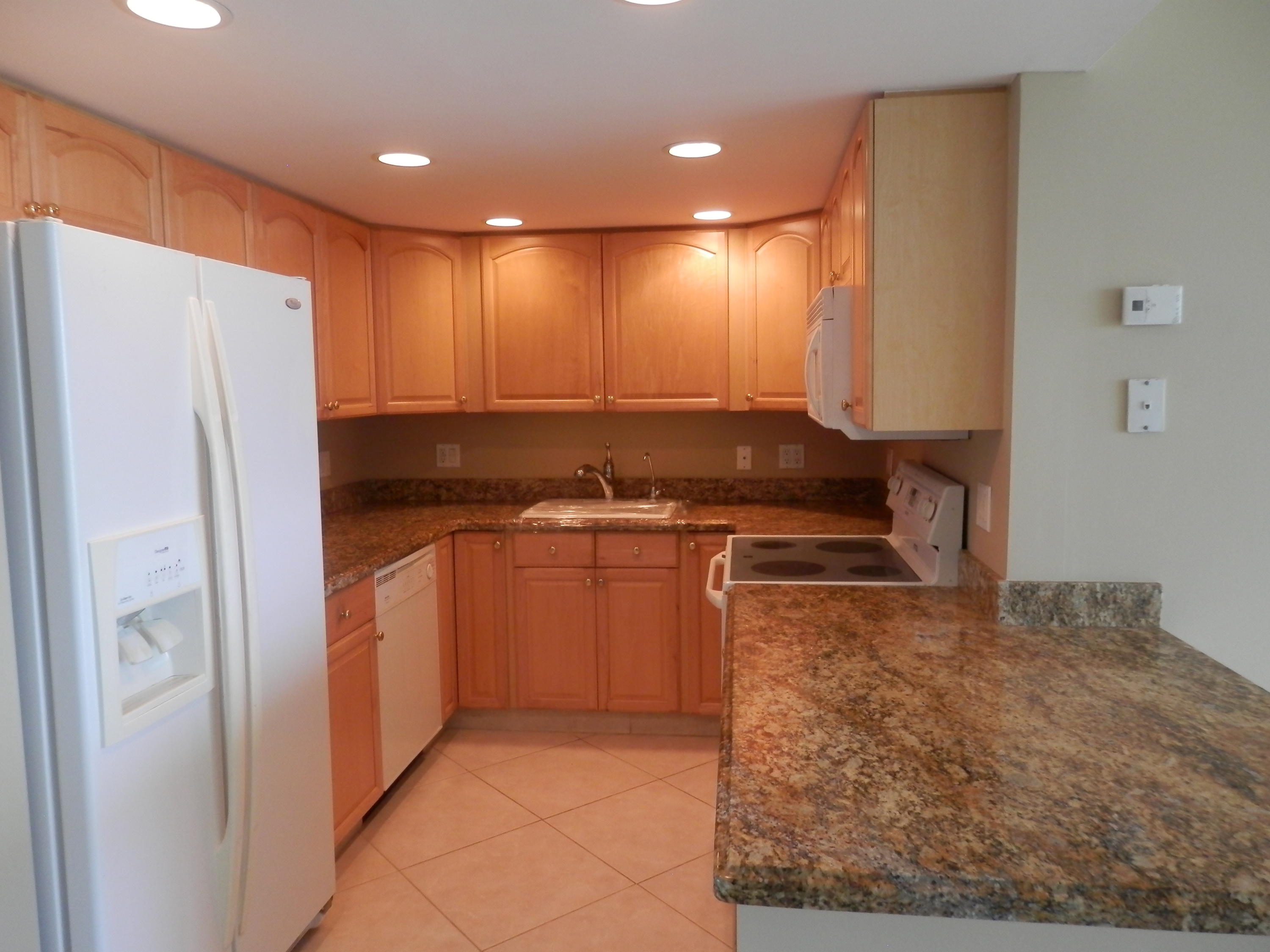 336 Golfview Road, Unit PH5 North Palm Beach, FL 33408 - Photo 3 of 11 a kitchen with stainless steel appliances granite countertop a refrigerator and a stove