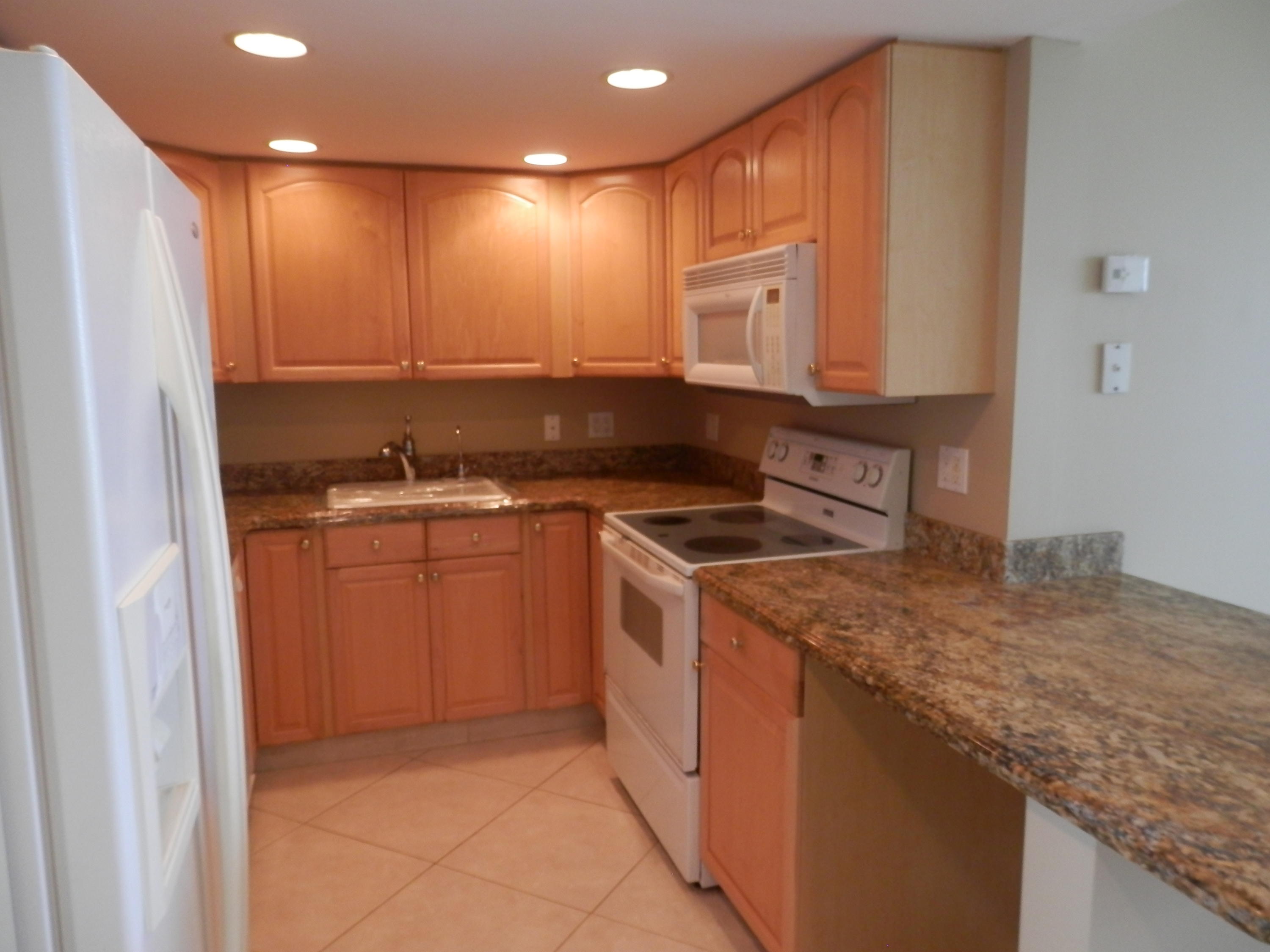 336 Golfview Road, Unit PH5 North Palm Beach, FL 33408 - Photo 4 of 11 a kitchen with a sink stove and cabinets