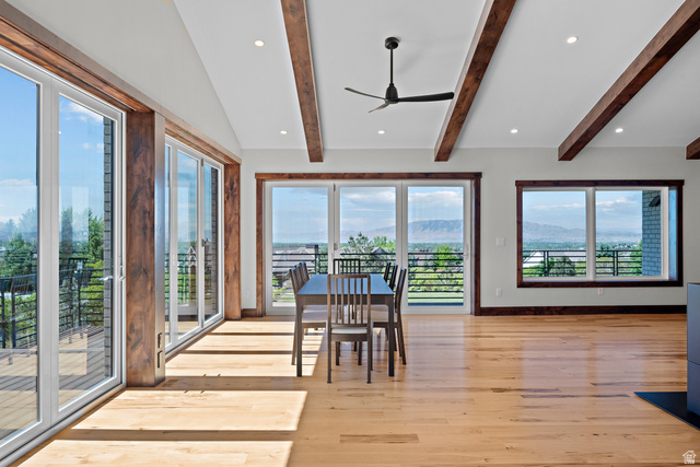 4221 Juniper Circle Alpine, UT 84004 - Photo 10 of 66 Expansive interior featuring wood-finish flooring, exposed ceiling beams, recessed lighting, and multiple oversized windows and glass doors with mountain scenery